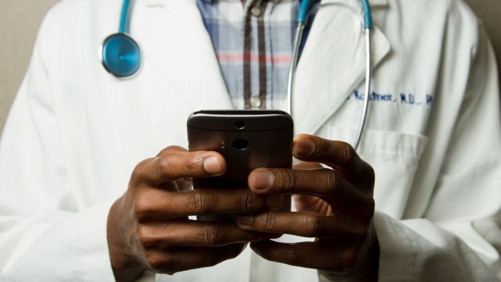 A doctor using their smartphone.